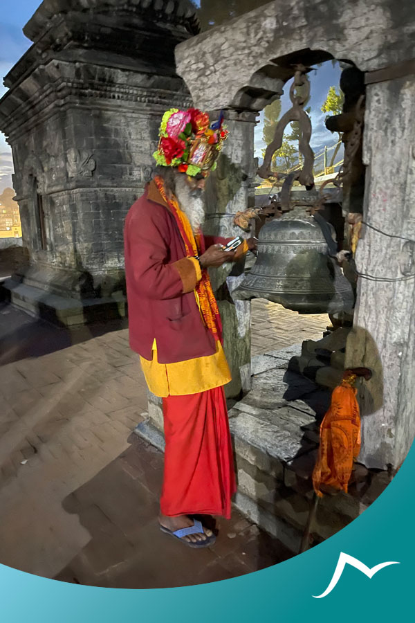 Sadhu-cheking-is-phone-at-Pashupatinath-Temple Sacred Delight: Enchanting Aura of Pashupatinath Temple in the Evening